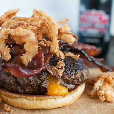 Cheddar Stuffed Burger topped with Fried Onion Strings and Candied Bacon